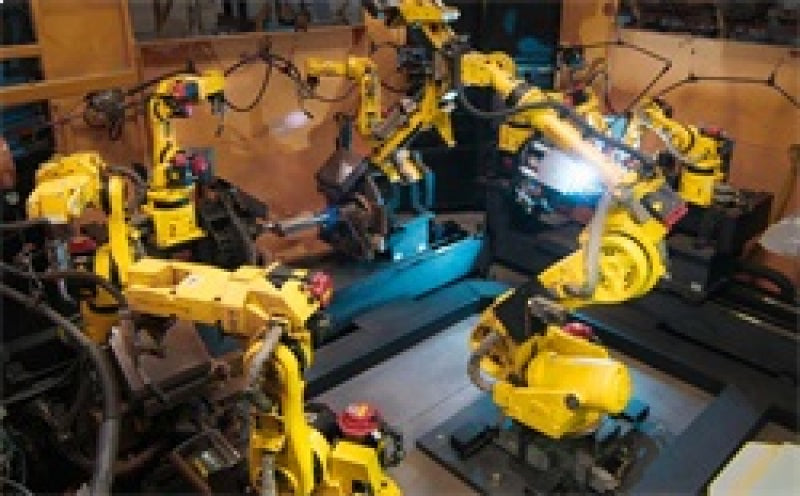 Industrial robotic arms in a manufacturing environment.