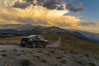 Fox 3.0 Factory Race Series Live Valve Internal Bypass Coilover Shock 2019+ Ford Raptor - Front on rugged off-road trail.