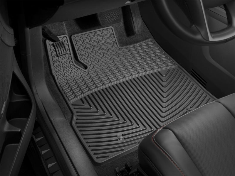 WT Rubber Mats - Rear - Blk in a vehicle floor with textured design.