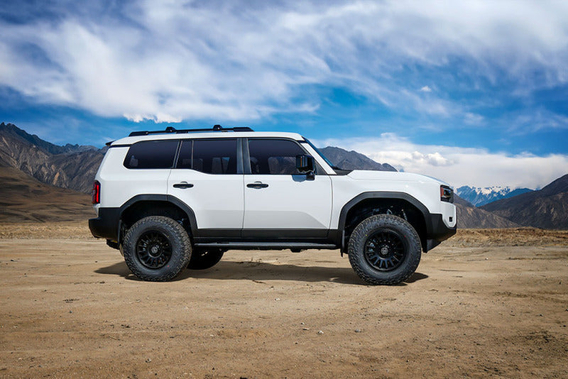 ICON 2024+ Toyota Land Cruiser 250 Series Front 2.5 VS IR Coilover Kit on offroad wheels and tires in scenic landscape.