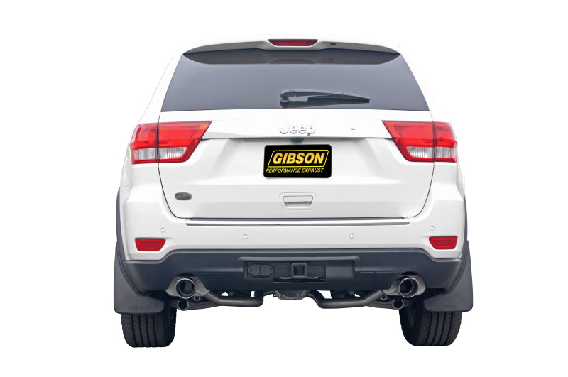 Gibson 11-18 Jeep Grand Cherokee Laredo 3.6L 2.25in Axle-Back Dual Exhaust - Stainless on white Jeep rear view.