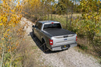 BAK 19-21 Chevy Silverado/GM Sierra Revolver X4s 5.10ft Bed Cover (New Body Style) on offroad truck in nature.