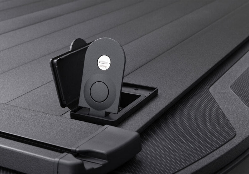 Retrax 2007-2020 Toyota Tundra CrewMax 5.5ft Bed RetraxPRO XR with Deck Rail System open with phone holder.
