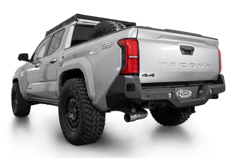 Addictive Desert Designs 2024 Toyota Tacoma Stealth Rear Bumper on truck with offroad tires and performance upgrades.