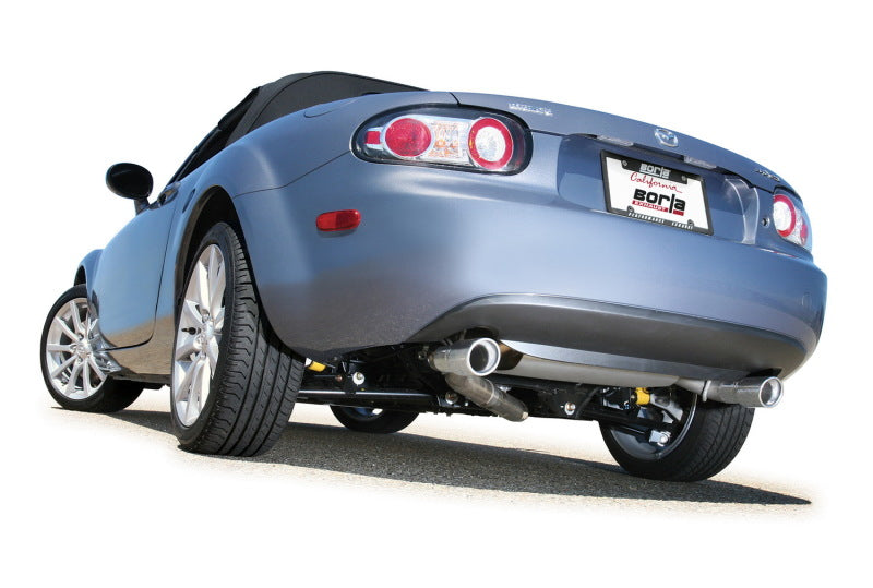 Borla 06-14 Mazda MX-5 Miata 2.0L RWD Twin-Tip Cat Back Exhaust installed on a silver convertible car.