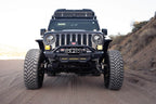 DV8 Offroad 18-23 Wrangler JL/Gladiator JT Spec Series Front Bumper on rugged terrain with offroad tires.