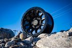 ICON Hulse 18x9 6x5.5 25mm Offset 6in BS Double Black wheel on rocks