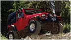 Bushwacker 97-06 Jeep TJ Max Pocket Style Flares 4pc - Black on off-road terrain