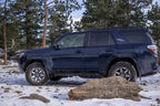 N-Fab Trail Slider Steps 10-20 Toyota 4Runner (Excl. 10-19 Limited / 10-13 SR5) - Textured Black on offroad terrain.