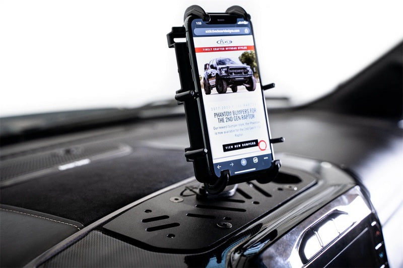 Addictive Desert Designs 21-23 Dodge Ram TRX Digital Device Dash Mount holding a smartphone on a truck dashboard.