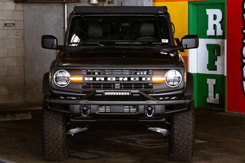 DV8 Offroad 21-22 Ford Bronco Factory Modular Front Bumper Bull Bar on black Ford Bronco in garage