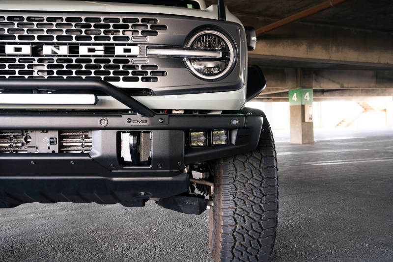 DV8 Offroad 21-22 Ford Bronco Factory Bumper Pocket Light Mount (Pair) 3in LED Pod Lights on parked Bronco.