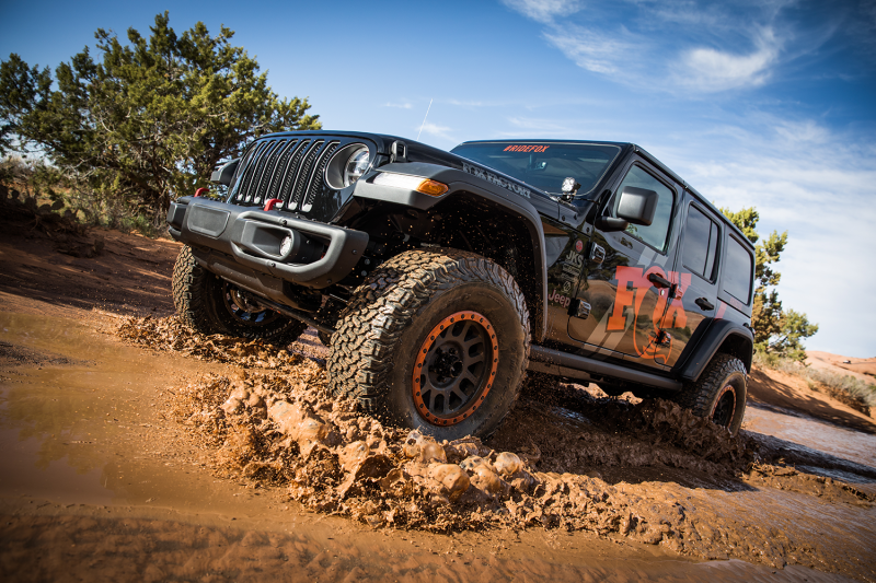 Fox 2018+ Jeep JL 2.5 Factory Race Series 9.7in Remote Res. Front Shock Set / 0-1.5in. Lift w/ DSC in action on off-road terrain.