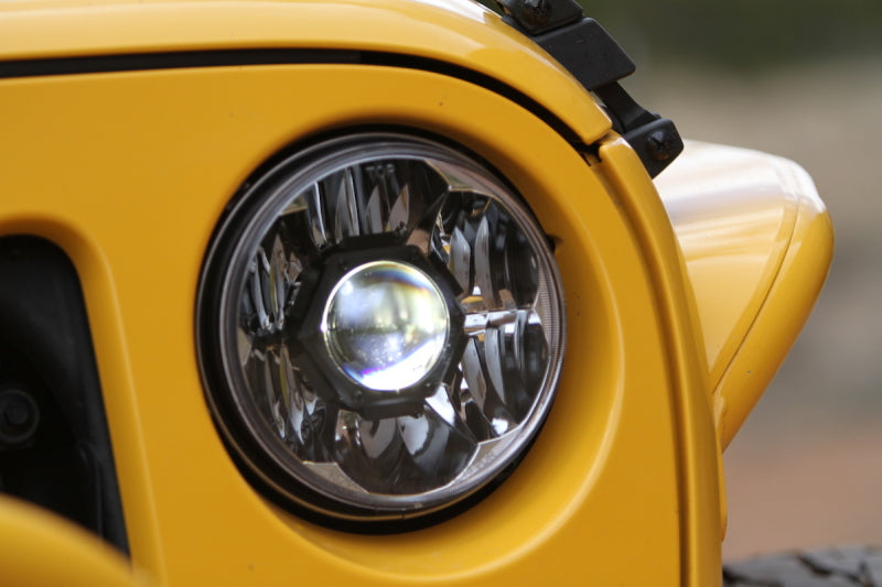 KC HiLiTES 07-18 Jeep JK 7in. Gravity LED Pro DOT Approved Replacement Headlight (Single) close-up on yellow Jeep