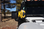 KC HiLiTES 6in. Round Soft Cover (Pair) - Black w/Yellow KC Logo mounted on off-road vehicle