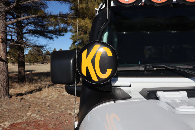 KC HiLiTES 6in. Round Soft Cover (Pair) - Black w/Yellow KC Logo mounted on off-road vehicle