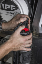 Hands operating the ARB Hydraulic Recovery Jack for offroad use