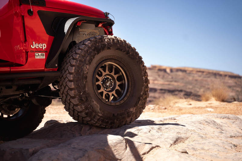 DV8 Offroad 2018+ Jeep Wrangler JL Front Inner Fenders - Black on lifted tire in rocky terrain.