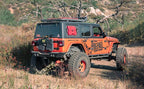 MagnaFlow 19+ Jeep Wrangler JL Overland Series Cat-Back Performance Exhaust System on off-road Jeep with rebel graphics.