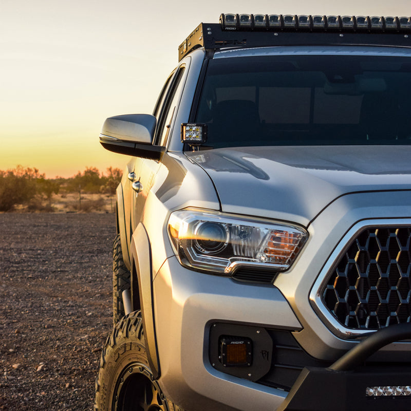 Rigid Industries 16-20 Toyota Tacoma A-Pillar Light Kit w/D-SS Flood on off-road truck in desert sunset.