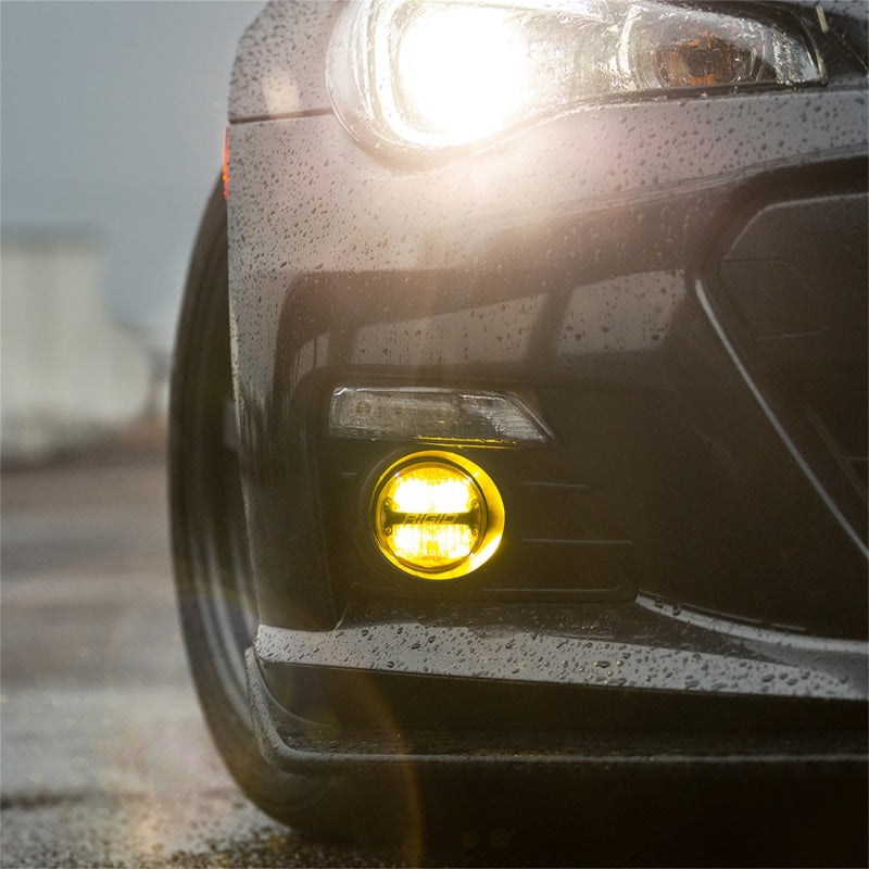 Rigid Industries 360-Series 4in LED SAE J583 Fog Light - Selective Yellow (Pair) on a black car front