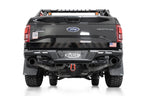 Addictive Desert Designs17-20 Ford F-150 Raptor Phantom Front Bumper on offroad truck with exterior accessories.