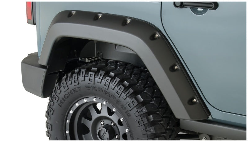 Bushwacker 07-18 Jeep Wrangler Unlimited Pocket Style Flares 2pc 4-Door Sport Utility Only - Black on offroad tire.