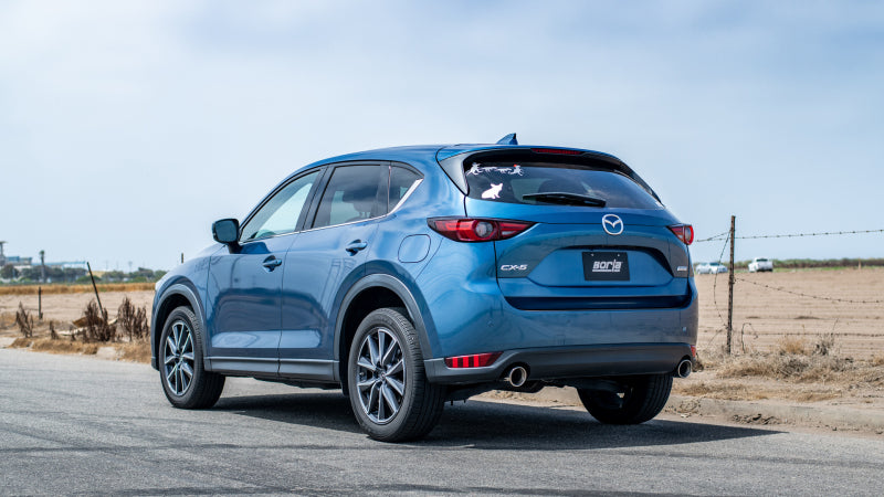 Borla 17-20 Mazda CX-5 2.5L AT AWD 4DR 2in S-Type Rear Section Exhaust on blue CX-5 in a scenic setting.