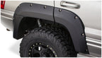 Bushwacker 99-04 Jeep Grand Cherokee Cutout Style Flares 2pc - Black on offroad truck with tires