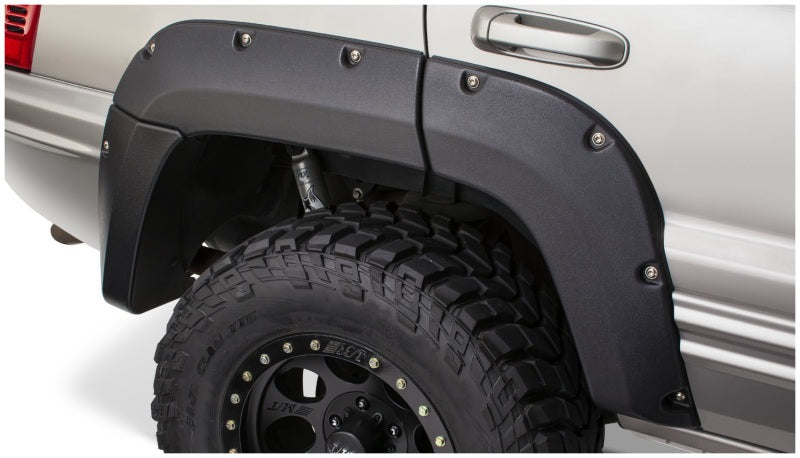 Bushwacker 99-04 Jeep Grand Cherokee Cutout Style Flares 2pc - Black on offroad truck with tires