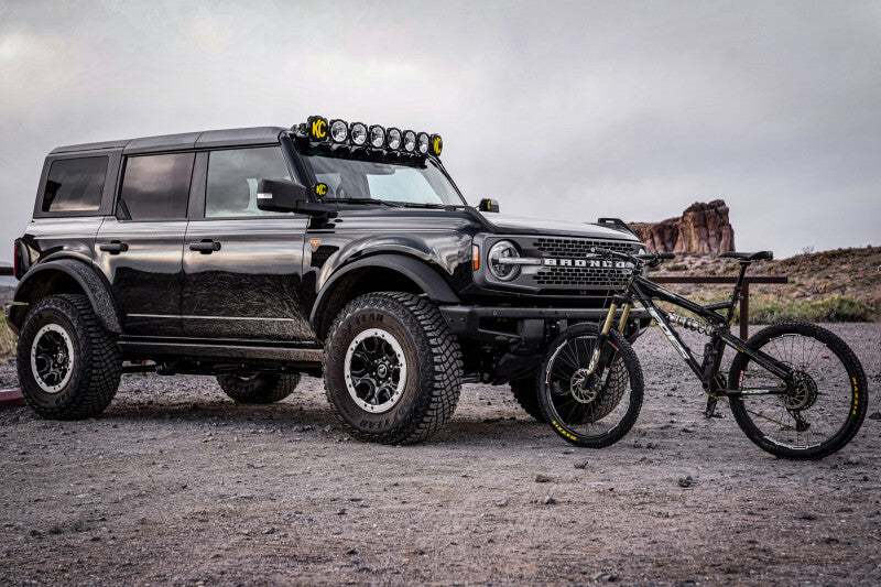 KC HiLiTES 2021+ Ford Bronco 50in Overhead Light Bar Mounting Bracket Set on black Bronco with bike.
