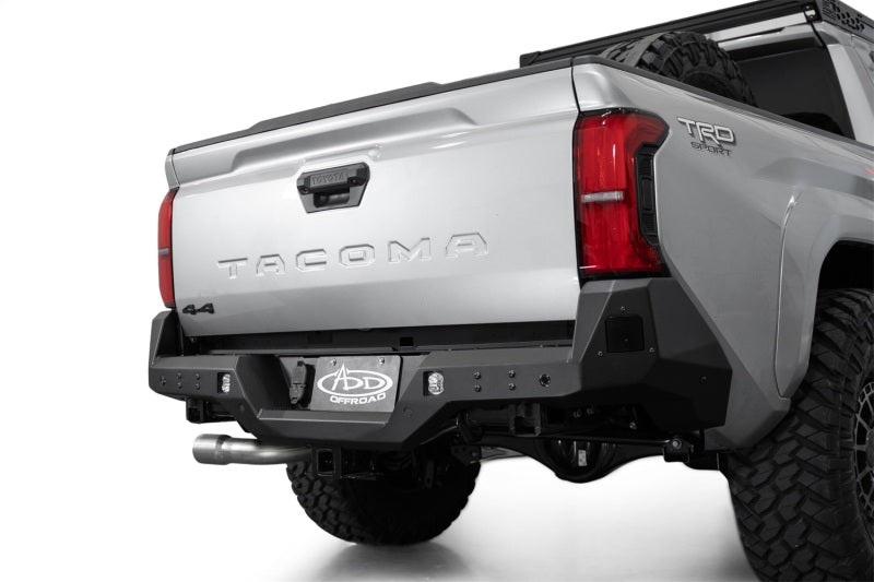 Addictive Desert Designs 2024 Toyota Tacoma Stealth Rear Bumper on a truck showing off-road accessories.
