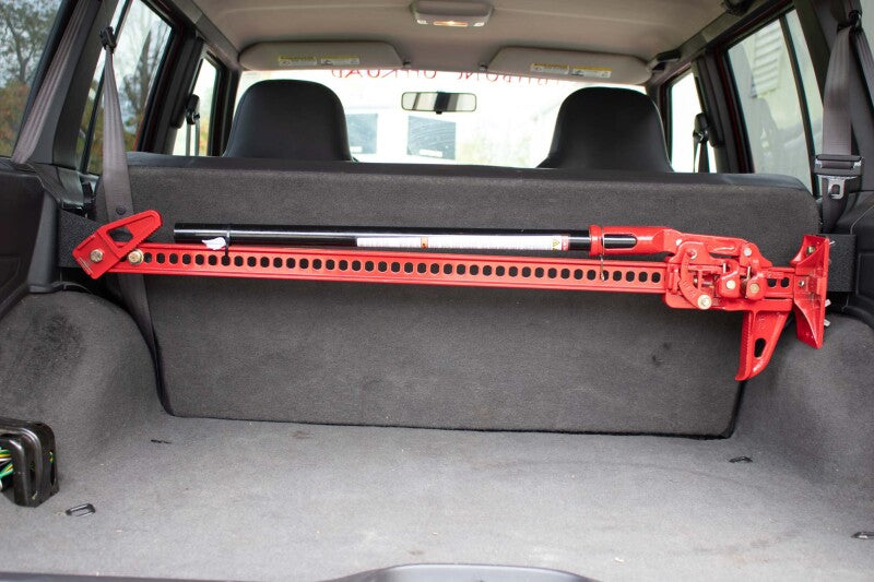 Fishbone Offroad 84-01 Jeep Cherokee XJ Rear Seat Hi-Lift Jack Mount installed in vehicle for offroad use.