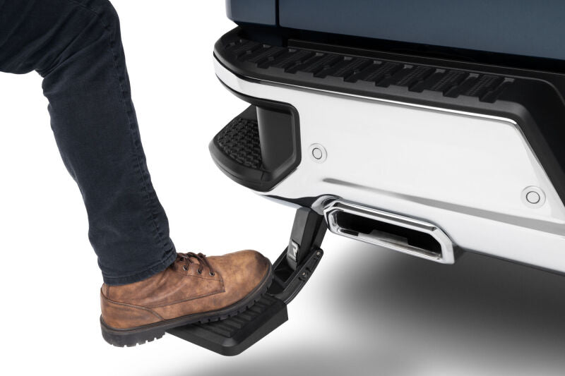 AMP Research 19-22 Chevrolet/GMC Silverado/Sierra 1500 BedStep - Black being used with foot on bumper step.