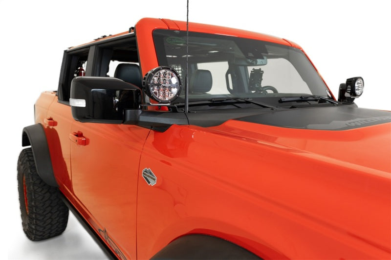 Addictive Desert Designs21-23 Ford Bronco/Raptor Dual Ditch Light Brackets mounted on a truck for offroad lighting.