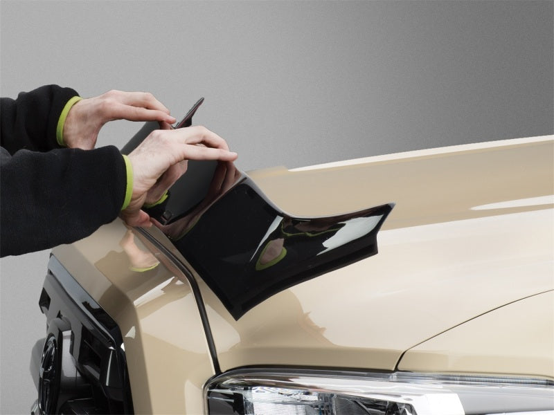 Attaching WeatherTech 2019+ Chevrolet Silverado 1500 Hood Protector - Black for durable exterior protection. Main image