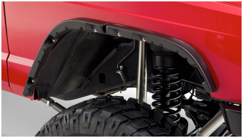 Bushwacker 84-01 Jeep Cherokee Flat Style Flares 4pc - Black installed on a Jeep with offroad performance upgrades