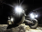 Rigid Industries Rock Light Kit- Cool White (4 lights) illuminating off-road vehicle on rocky terrain.