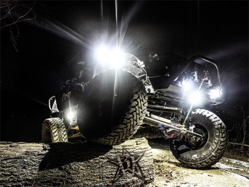 Rigid Industries Rock Light Kit- Cool White (6 lights) illuminating off-road vehicle at night.