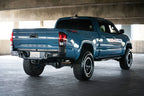 DV8 Offroad 16-23 Toyota Tacoma MTO Series Rear Bumper installed on blue Tacoma truck