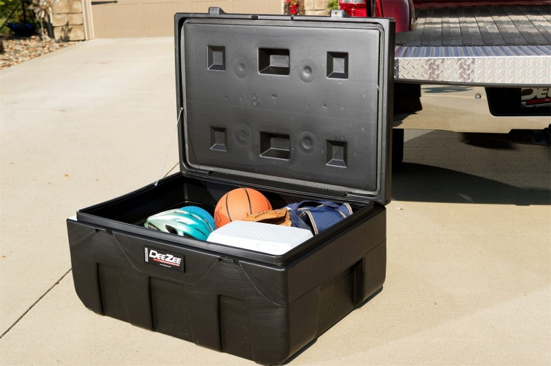 Deezee Universal Tool Box - Specialty Utility Chest Plastic 37In in use for storage outside a vehicle.