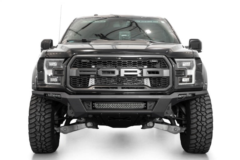 Addictive Desert Designs17-20 Ford F-150 Raptor Phantom Front Bumper with offroad tires and skid plates for trucks.