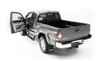AMP Research 2016-2017 Toyota Tacoma Double Cab/Access PowerStep - Black with open door, showcasing offroad accessories.