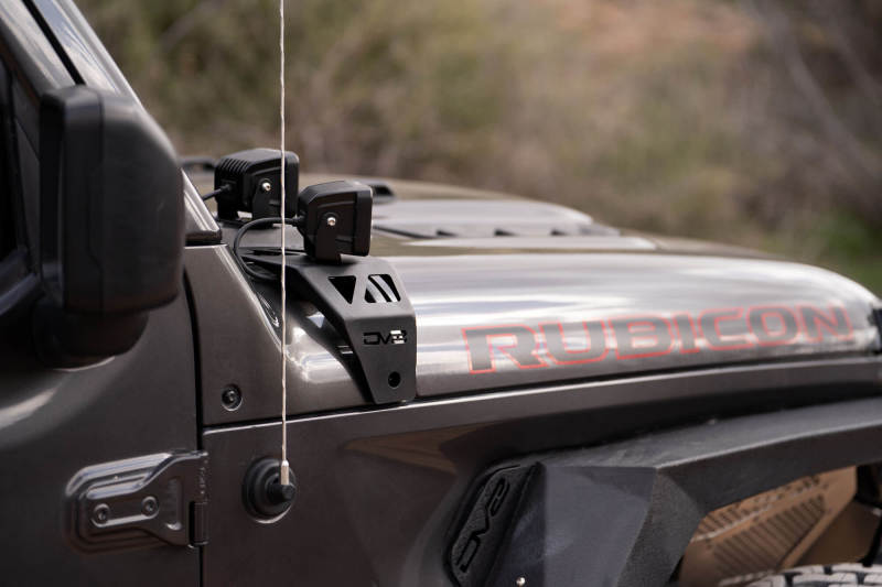 DV8 Offroad 18-22 Jeep Gladiator JT Cowl Light Bar Bracket installed on Jeep Rubicon for offroad lighting.