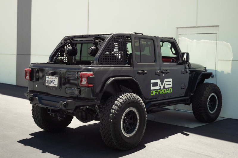 DV8 Offroad 18-23 Jeep Wrangler JL 4-Door Speaker/Light Bar Mount with upgraded offroad tires and accessories.