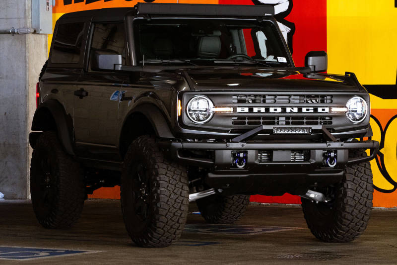 DV8 Offroad 21-22 Ford Bronco Factory Modular Front Bumper Bull Bar with offroad tires and rugged look.