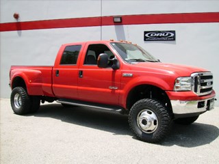 Red off-road truck with lifted suspension and offroad wheels, showcasing ORU brand parts and exterior accessories.