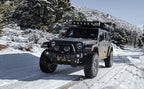 MagnaFlow 18-23 Jeep Wrangler JL 2.0L/3.6L Overland Series Axle-Back Exhaust in snowy off-road setting.