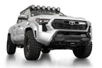 Addictive Desert Designs2024+ Toyota Tacoma Stealth Center Mount Winch Front Bumper w/ Top Hoop on lifted truck with offroad tires.
