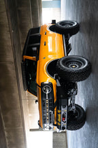 DV8 21+ Ford Bronco Curved Light Bracket for 12 3in. Pod Lights on yellow Ford Bronco with offroad tires and accessories.